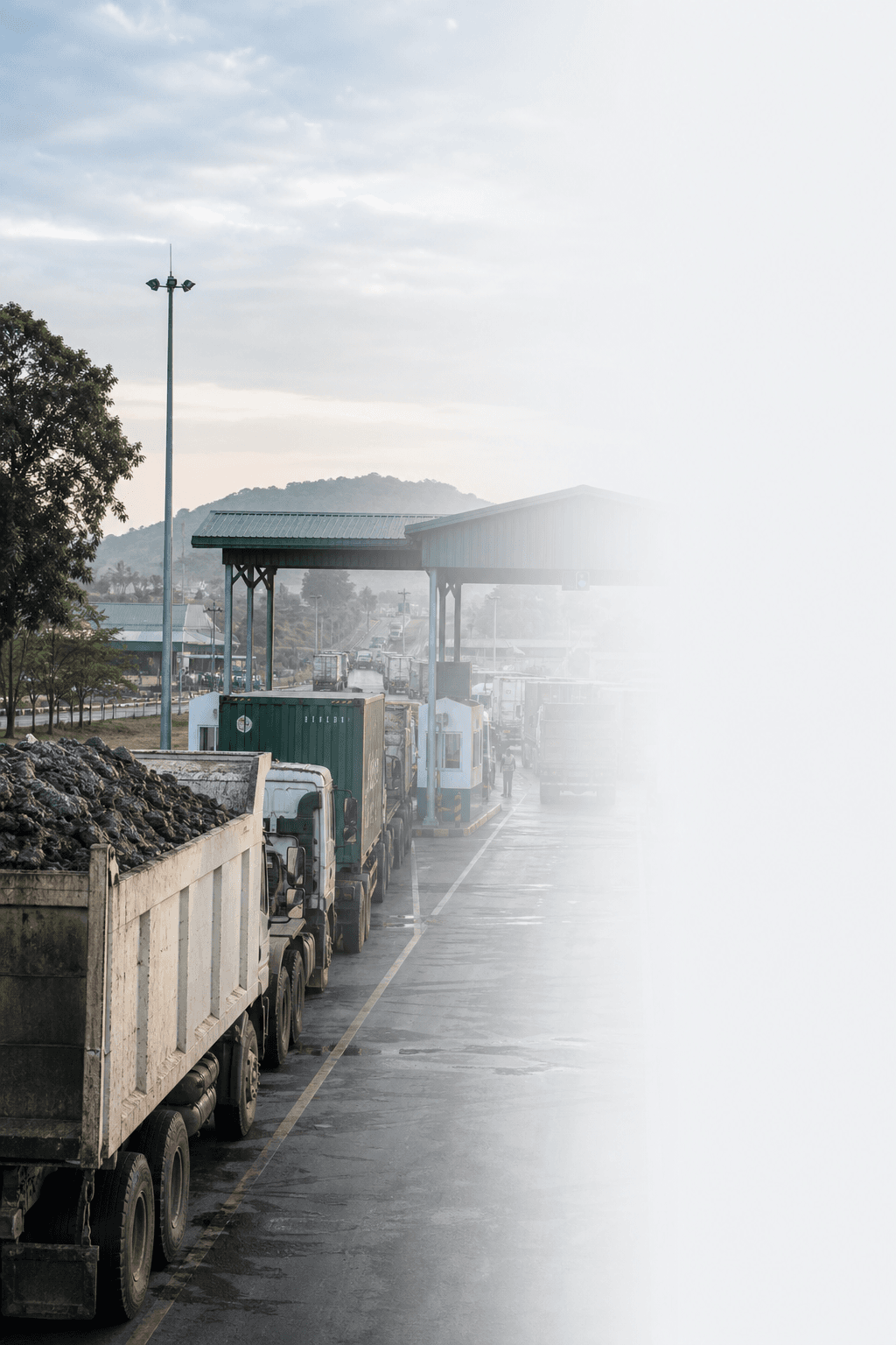 Kasumbalesa border trade corridor with cargo trucks at a checkpoint